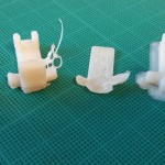 The learning curve. L-R: original part, two failed prints, successful print