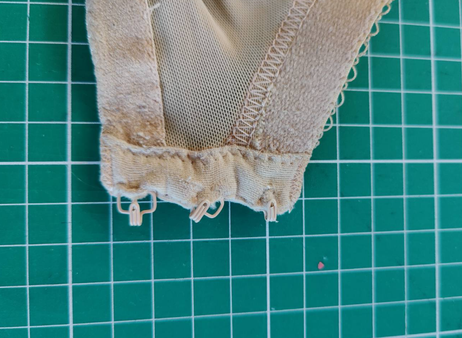 The hooks from the back of a bra, they're trying to escape their housing and are in need of replacement