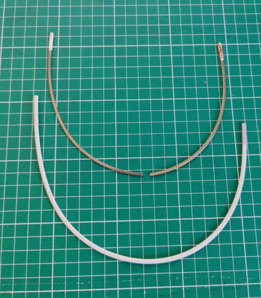 A broken wire and an unbroken wire on a cutting mat